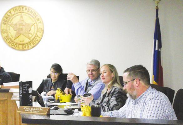 Sealy ISD Trustees John Sodolak, Katy Grigar and Brian Owen admire their gifts for School Board Recognition month at the beginning of last Wednesday’s regular meeting in the Administration Building. PHOTOS BY COLE McNANNA