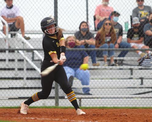 Sealy freshman Blair Kram lines up a pitch during the Lady Tigers’ district-opening contest at the Sealy High School Softball Stadium March 16. Kram added a home run to the Lady Tigers’ early-week win over Bellville. COLE McNANNA