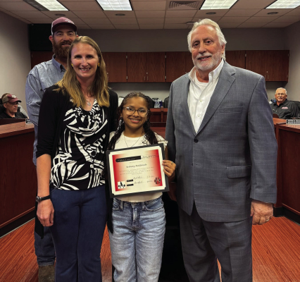 At the March regular board meeting, the board, along with Brazos Head Girls Powerlifting Coach Johanna Cromeans recognized Bethany Maldonado for placing 5th at the state level in the THSWPA Powerlifting meet. From left are Cromeans, Maldonado and Brazos Superintendent Dave Plymale. COURTESY PHOTO
