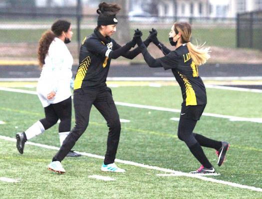 Coral Becerra (5) and Julieta Villagomez (11) celebrate Becerra’s game-opening score that put Sealy in front of Royal early in the District 20-4A contest on Mark A. Chapman Field at T.J. Mills Stadium last Friday. The pair scored first-half goals to give the hosts a 2-0 lead at halftime. Cole McNanna