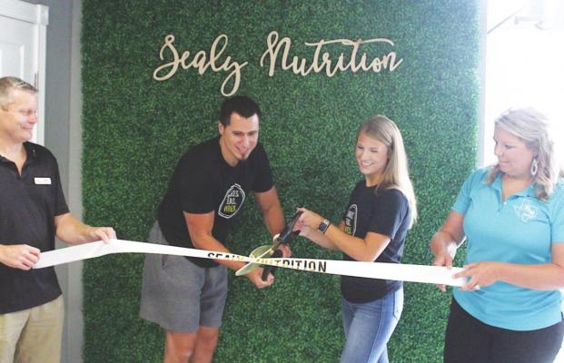 Sealy Nutrition owners Jonathan Patino and Michaela Cowan celebrated their ribbon-cutting event Aug. 5 at their shop on 203 Meyer Street. Holding the ribbon is Russ Rainwater and Tori Fisher. PHOTOS BY COLE McNANNA