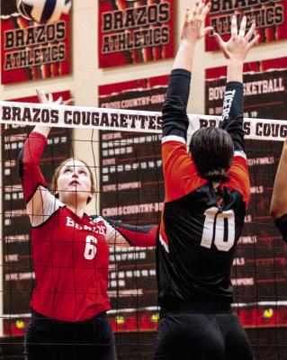 Maggie Richardson tips the ball over the net to score a point for the Cougarettes. SEALY NEWS | ALLISON DRINNON