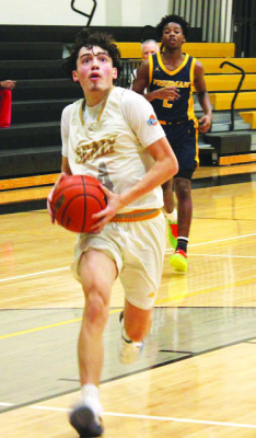 Sealy point guard Ian Alvarez drives the lain for two points in Sealy’s game against Katy Freeman in Sealy last Friday night.