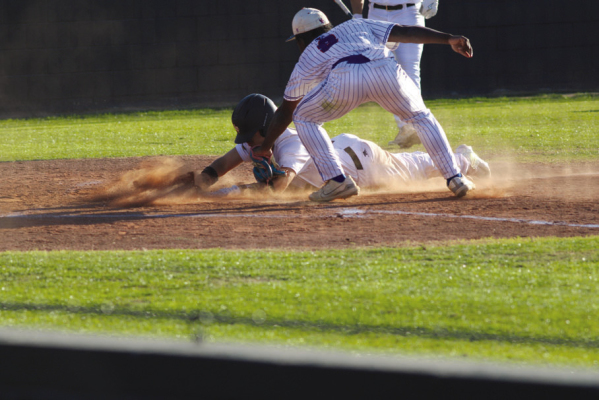 Julian Gomez slides into home plate just beating out the tag. SEALY NEWS | EVAN HALE