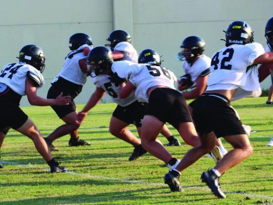 The Sealy Tiger football team has successfully completed its first week of fall football practice, and the coaches are pleased with the progress they’ve made. In this photo, the first defense is facing off against the junior varsity offense. The players from the left are Hunter Sodolak, Kane Stone, Jose Gomez, Reese Reichardt, and Clay Bartek. The ball carrier is not identified, but Kolton Gilbert and Ryland Ponce are also visible.