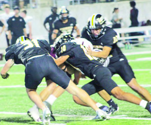 Sealy’s defenders Will Strickland, 31, Abraham Barrera, 10, and Ivan Murrillo, 32, swarm all over the Columbia ball carrier during last Friday nights area round playoff game. Sealy will now face West Orange-Stark in the regional round of the playoffs.