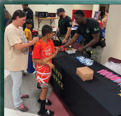 Members of the Austin County Sheriff’s Office and Youth and Family Services served the community during the Back-To-School Fair last week at Bellville High School. COURTESY PHOTO