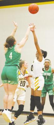 Sealy junior Jasmyne Joiner leaps to contest a shot from Cuero senior Ashley Price during the non-district game between the Lady Tigers and Lady Gobblers last Tuesday at Sealy High School. PHOTOS BY COLE McNANNA