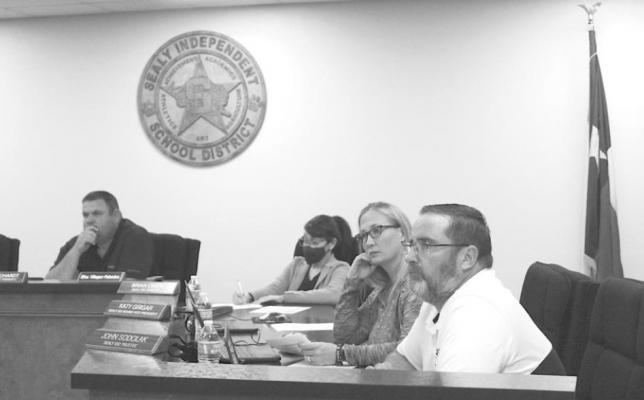 Sealy ISD Board of Trustee members John Sodolak and Katy Grigar listen to a presentation during last Wednesday’s regular meeting at the Administration Building. COLE McNANNA