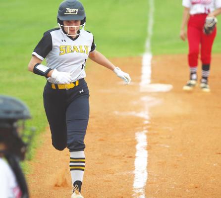 Sealy senior Callie Cooper sprints down the third baseline to score a run in the Lady Tigers’ district game at Royal High School April 19. PHOTOS BY COLE McNANNA