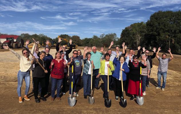 Members of the Sealy Christian Pantry celebrate the ground-breaking on the new office space on Old San Felipe Road. The building progress has been delayed for another month. SEALY NEWS FILE PHOTO