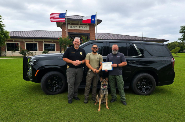 Sealy Police Officer Carlos Anaya (center) and Kajla recently completed their handler course and achieving their National Narcotic Detector Dog Association certification. Sealy PD Chief Russell Grimes (left) and an NNDDA representative stand with them. PHOTO FROM SEALY PD FACEBOOK