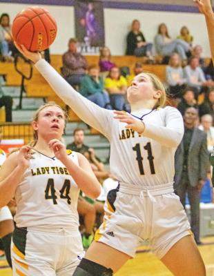 Sealy senior Evelyn Harrington drives for a contested layup during the Lady Tigers’ playoff game against Worthing at Morton Ranch High School Feb. 15. Harrington led her team with 15.3 points per game and was named the district’s offensive MVP. COLE McNANNA