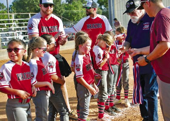 Players on the Brazos Coach Pitch All-Star team receive their silver medals. COURTESY PHOTO