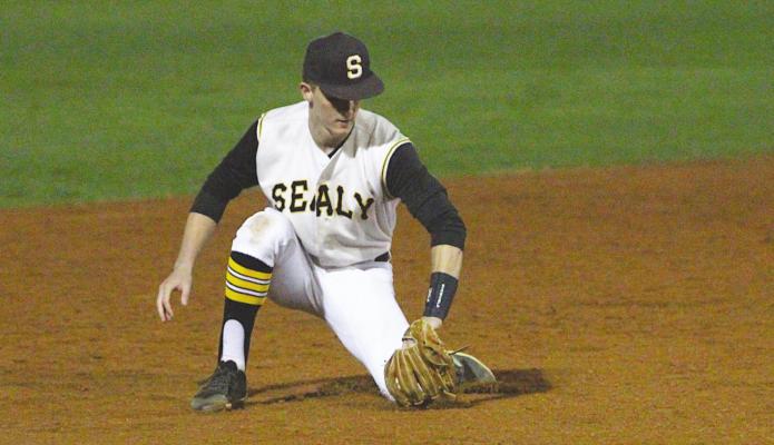 Sealy senior Tyler Hennessey fields a ground ball on the backhand during a non-district game against Needville March 2 at Aubrey”Mutt"Stuessel Stadium. PHOTOS BY COLE McNANNA