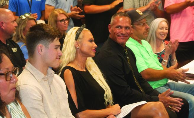 Clint Finley looks over at his family as it was announced his selection as new AD/head football coach for Sealy ISD. PHOTOS BY JIMMY GALVAN