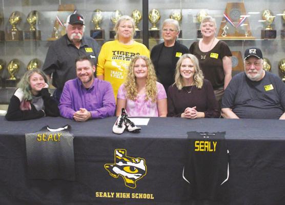 Madison Manak was joined by family at a May 26 signing ceremony where she made her commitment to run for Jacksonville Junior College.