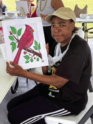 Hazel Bolden holds the painting she completed at the Sealy Eastside Foundation Paint &amp; Picnic event last week.