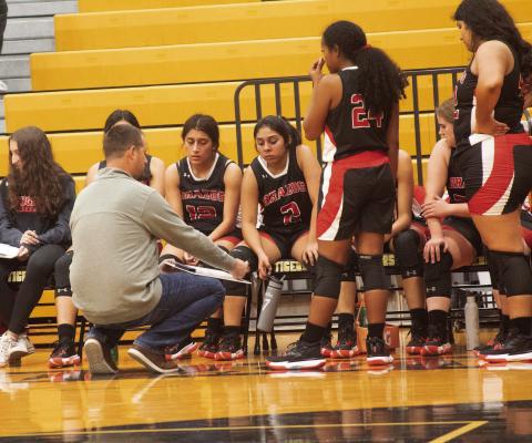 Brazos Head Girls Basketball Coach Griffin Clary talks with his team during a timeout. PHOTO BY JIMMY GALVAN