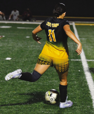 Yasmin Arriaga kicks the ball into an open area for her teammate to grab.