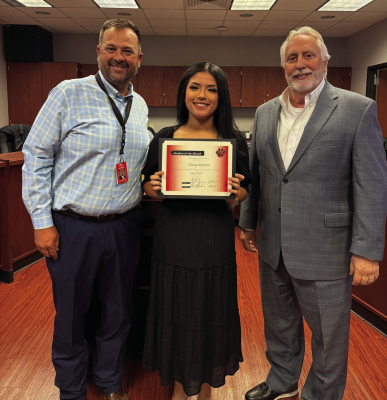 At the March Brazos Independent School District Board meeting, BHS Student of the Month Odalys Romero led the Pledge of Allegiance and Texas Pledge. BHS Principal Clay Hudgins praised her as a friendly, reliable student who always has a smile. What truly set her apart was her bravery. On March 17, Odalys acted without hesitation at the scene of a fatal crash, helping remove a victim from a burning vehicle. From left, Hudgins, Odalys Romero and Superintendent Dave Plymale. COURTESY PHOTO