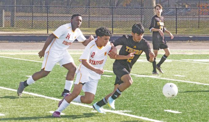 Sealy’s Max Requena battles a trio of Stafford players for a loose ball during first half action against the Spartans in the season opener last week. PHOTOS BY JIMMY GALVAN