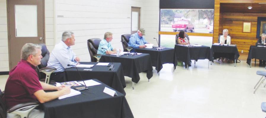 Russ Rainwater, Bradley Miller, Sterling Shiller, Larry Koy, Yvonne Johnson, Kimbra Hill and Steven Kutra focused their attention during the Main Street Manager’s Report during last Tuesday’s EDC meeting, Sept. 28. HANS LAMMEMAN