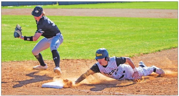Sealy junior Dillon Dornak slides back into first base safely after a pick-off attempt during the Tigers’ non-district contest against Giddings at home last Tuesday, March 15. COLE McNANNA