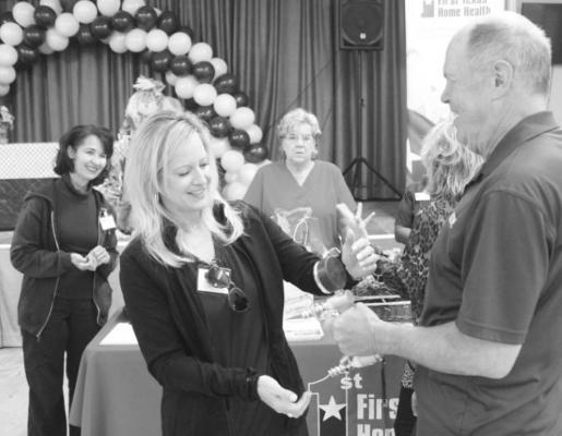 Occupational Therapist Shannon Roberts reading the results to Perry Ford’s attempt at the Strongest Man/Woman contest that evaluates grip strength. HANS LAMMEMAN