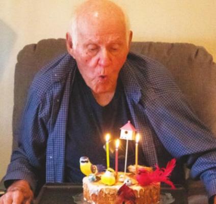 Lou Zapalac prepares to blow the candles out on his 92nd birthday cake during a Monday afternoon celebration in Sealy.