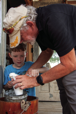 Wyatt Brooks and his grandfather Jim Brooks scoop handmade ice cream into a cup during the Sealy Spring Fest, Saturday, April 11, at the Sealy Historical Park.