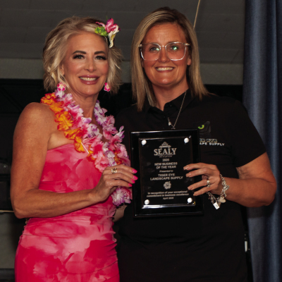 Claudia Batton (left), president and CEO of the Greater Sealy Chamber of Commerce, presents the New Business of the Year award to Tiger Eye Landscape Supply, represented by Tiffany Jackson, Friday, April 17, at the Sealy American Legion Hall.
