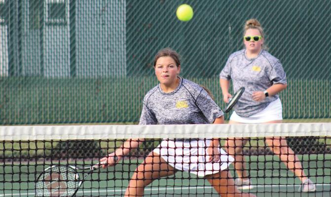 Trinity Harding moves to return a volley during her doubles match with Abigail Zientek against El Campo last Tuesday at home. PHOTOS BY COLE McNANNA