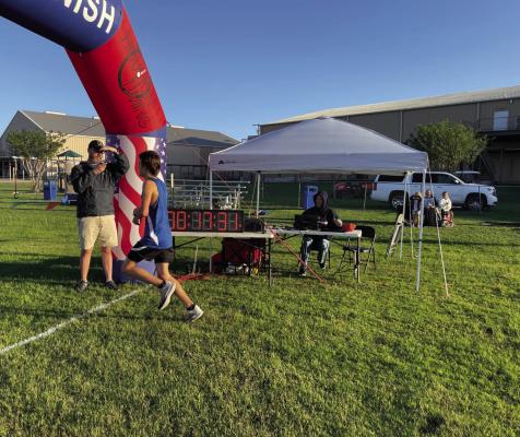 Faith Academy’s Ethan Stegent crosses the finish line in first place at the Faith Academy 5th annual Cross Country Meet. COURTESY PHOTO