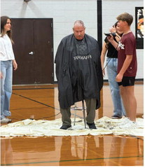 Brooklyn Konesheck (left) and Grant Ellis (right) along with Letty Becerra (back right) shave Walt Winicki’s h ead. COURTESY PHOTO