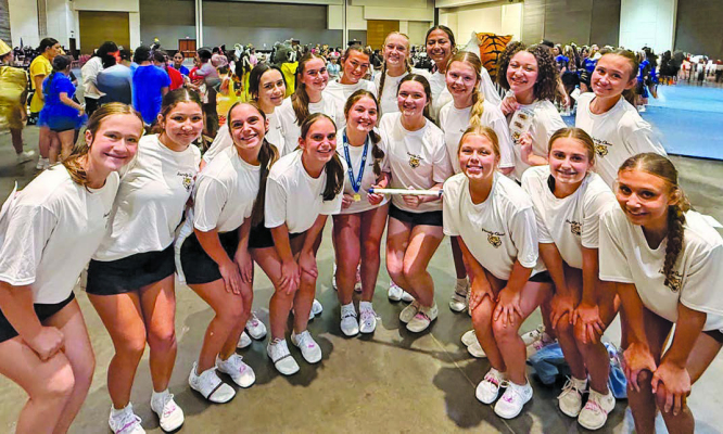 The Sealy cheer squad pose for a picture with the spirit stick during the UCA Camp at the University of Texas at San Antonio on July 19-24. COURTESY PHOTO