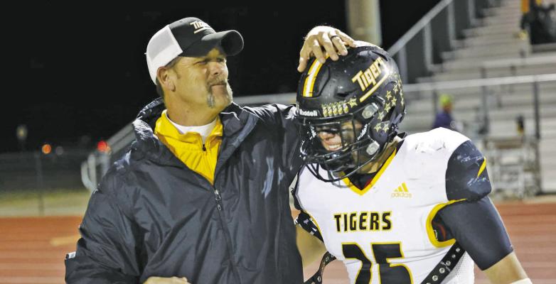 Sealy’s Shane Mobley pats the head of Richard Hahn during Friday’ contest with Cuero. PHOTO BY ELIJAH BROWN