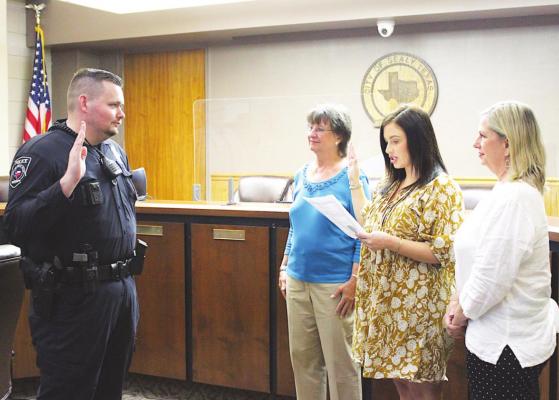 Sealy Patrol Officer Hunter Janicek is sworn in to the Sealy Police Department by Mayor Carolyn Bilski, City Secretary Brooke Knoll and Councilwoman Dee Anne Lerma during a ceremony in the council chambers of city hall June 1. AMANDA LUKSHA