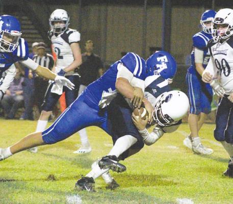 Faith Academy senior Nathan Figueroa lays the boom on one of his team-leading 12 tackles in the Knights’ home-opening loss last Friday at SAB Stadium in Bellville. COLE McNANNA