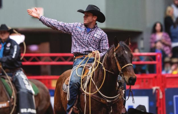 Bellville native Caleb Smidt acknowledges the crowd after his tie-down roping performance at the American Rodeo Semi-Finals that earned him a spot in the finals earlier this year. Last week, Smidt and his horse Pockets claimed their third tie-down roping world title at the National Finals Rodeo in Las Vegas, NV. JACK LINK, THE AMERICAN RODEO/RURAL MEDIA GROUP