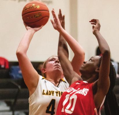 Sealy senior Julia Jurecka goes up for a contested shot in the first half of the Lady Tigers’ District 24-4A contest against Royal at home last Friday. Jurecka scored six points in the first quarter and seven points in the second quarter to help erase a 12-0 deficit. PHOTOS BY COLE McNANNA