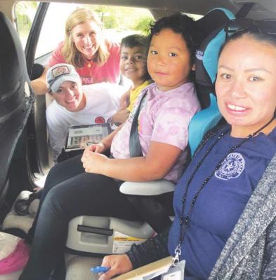 Technicians Rachel Kubala, Kim Sodek and Maria Alvarez helped conduct car seat checkups during the Nov. 20 event in Wallis to make the community aware of the importance of our children riding safely. CONTRIBUTED PHOTO
