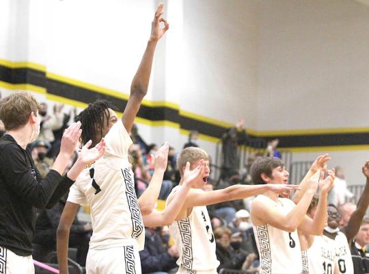The Tiger bench celebrates Connor Krenek’s three-pointer in the fourth quarter of the final district contest of the regular season against Bellville last Friday. Cole McNanna