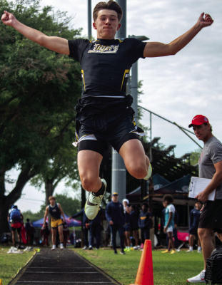 Brady Cranfill launches himself forward for a long jump during the district track and field meet, Wednesday, April 8, at TJ Mills Stadium in Sealy. PHOTO BY THE SEALY NEWS | ALLISON DRINNON