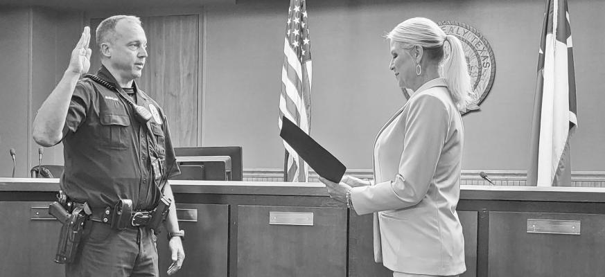 On Sept. 7, David Buehler was sworn in as the newest police officer with the Sealy Police Department. Buehler was surrounded by family and co-workers during the ceremony held at city hall. Buehler graduated Gus George Police Academy in July 2022. Prior to that, he worked in the private sector of sales. Buehler will be assigned to the Patrol Division. Sealy City Manager Kimbra Hill is pictured administering the Oath of Office to Buehler. CONTRIBUTED PHOTO