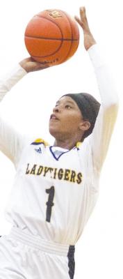Sealy sophomore Taniah Coleman goes up for a firsthalf shot during the Lady Tigers’ Bi-District Championship against the Worthing Colts Feb. 15 at Morton Ranch High School. COLE McNANNA