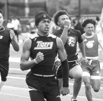 Bryce Mack grits his teeth as he sprints down the track during the 100m dash.