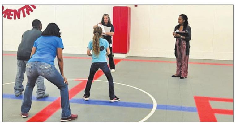 During the eight-week program, Walk Across Texas, students at West End Elementary had the chance to broaden their knowledge of the food groups by playing the MyPlate Challenge. Pictured are Tammy Wendel, Michelle Wright, Z’Aundria Warren and two West End students. CONTRIBUTED PHOTO