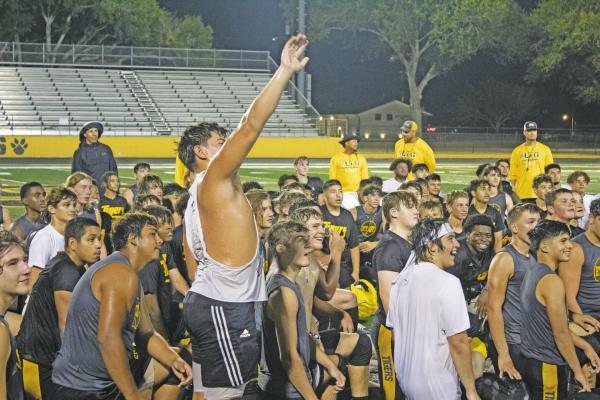 JASON MANAGO-GRAVES Richard Hahn of the Sealy High School varsity team is pictured waving into the stands following last week’s Midnight Madness practice session. Head coach Shane Mobley made it important for all players to acknowledge their friends and family who came out to support them.