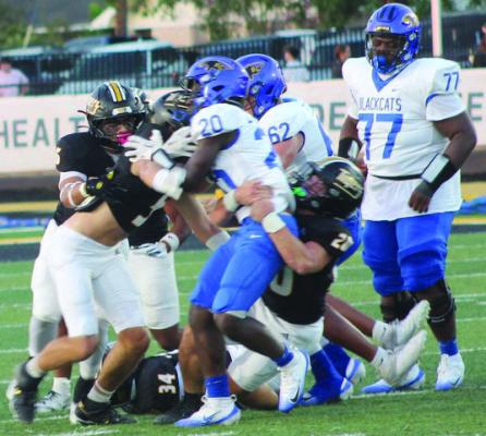 Sealy defenders Hunter Sodolak, 20, Isaiah Dukes-Self, 34, Beau Finley, 5, and Jadon Hernandez, 16, swarm all over Bay City running back Allen Dunlap, 20, stopping him for no gain. PHOTOS BY HERBIE KOLLATSCHNY